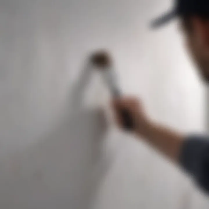 A close-up of a paintbrush applying a coat of paint on a freshly primed wall