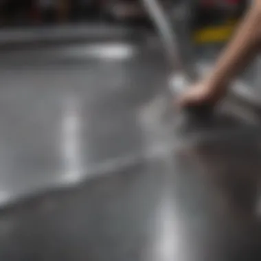 A close-up of a stainless steel surface being cleaned