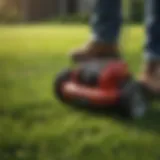 Manual lawn aerator in use on grass