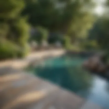 Natural stone pool deck surrounded by greenery