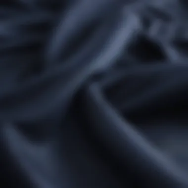 Close-up of luxurious navy blue fabric used in coastal bedding.