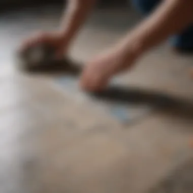 A close-up of a tile being lifted from the floor.